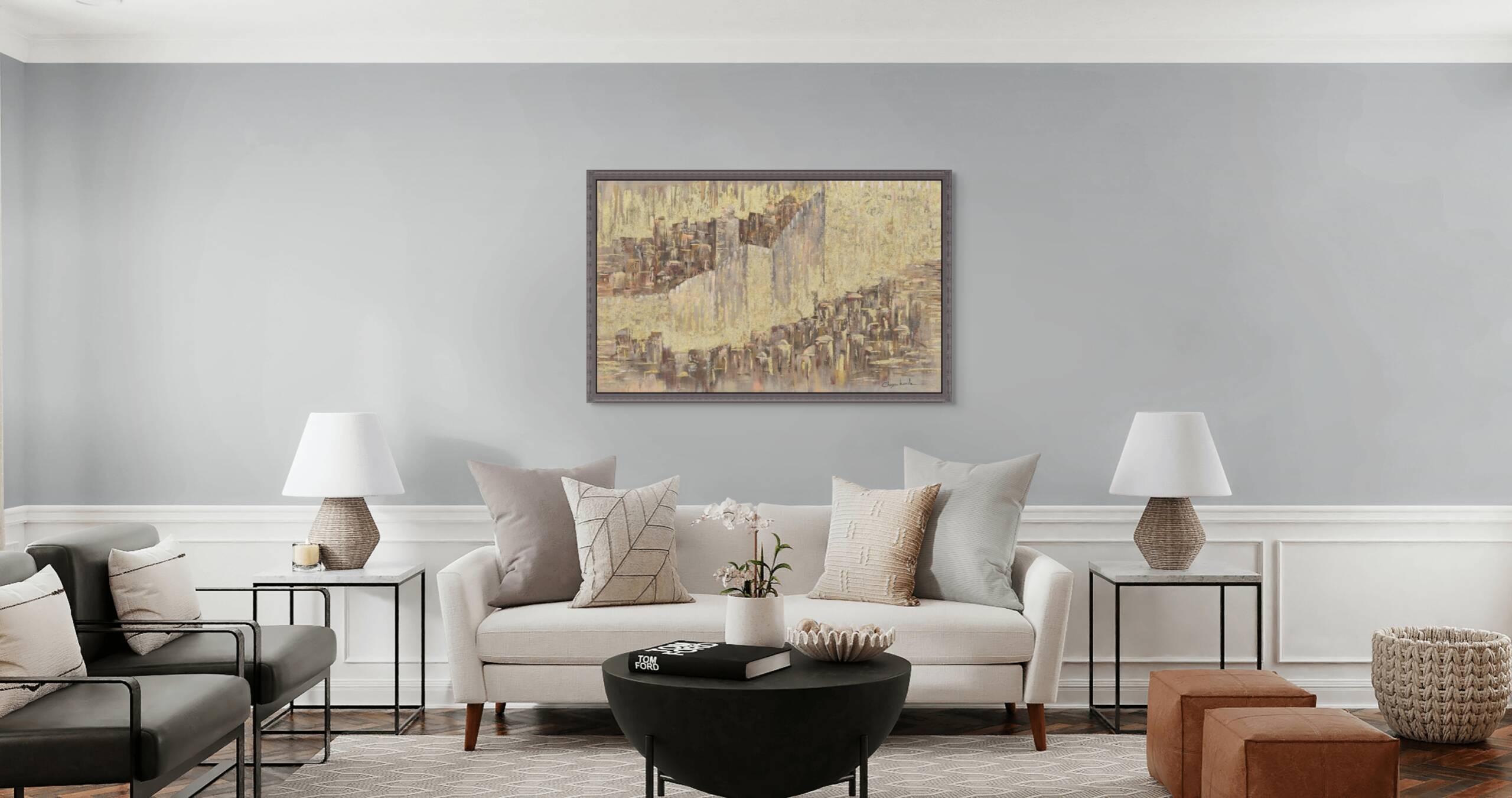Framed artwork of Jerusalem with gold leaf, hanging in a modern living room above a neutral-toned sofa.